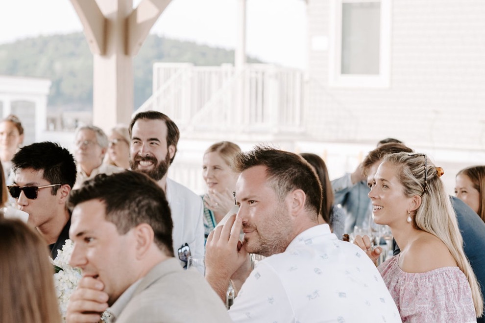 guests laughing during outdoor pier dinner
