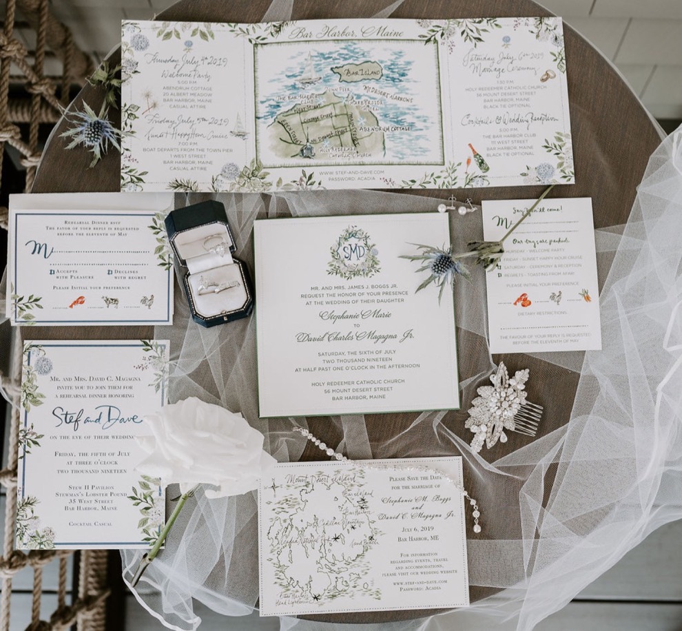 coastal themed blue and floral wedding invitation suite, rings, and jewelry