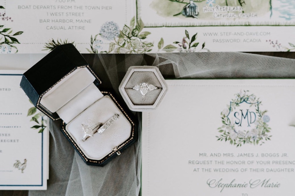 wedding and engagement rings in dark blue velvet box
