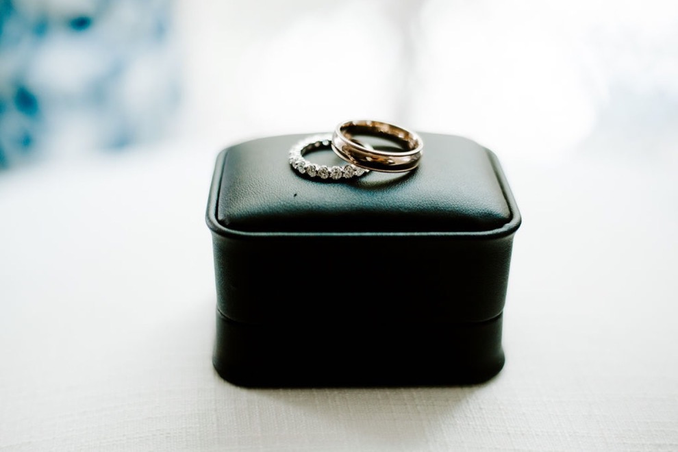 wedding bands on black leather box