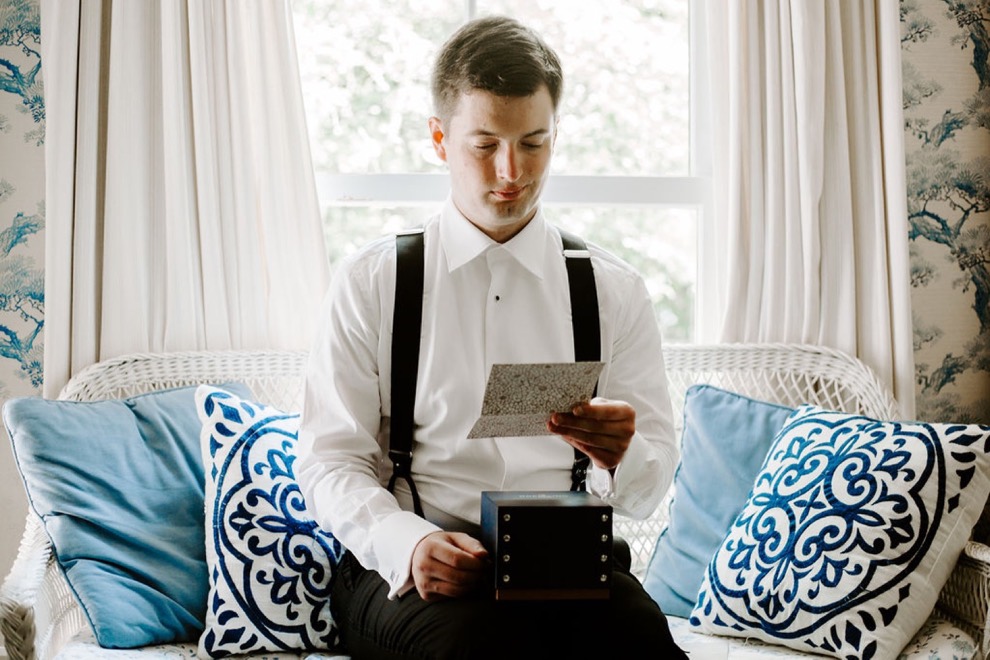 groom reading letter on wedding day