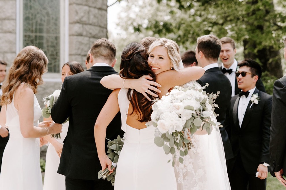 bride hugging guest after church wedding 
