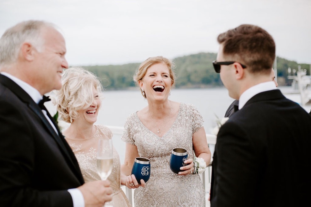 guests laughing while drinking champagne