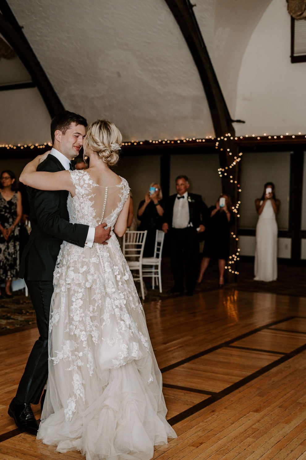 bride and groom first dance at indoor wedding reception