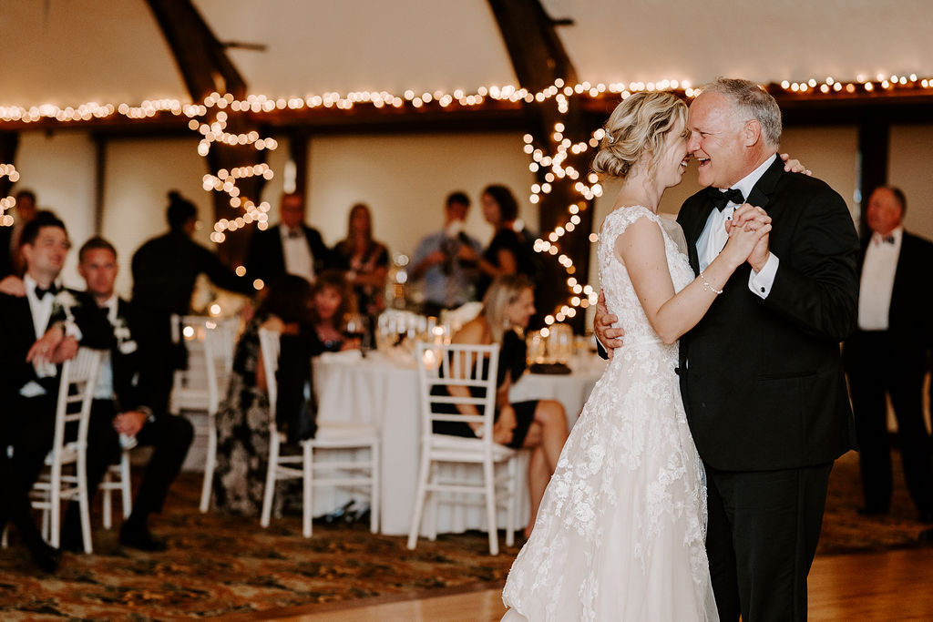bride dancing with father during indoor wedding reception