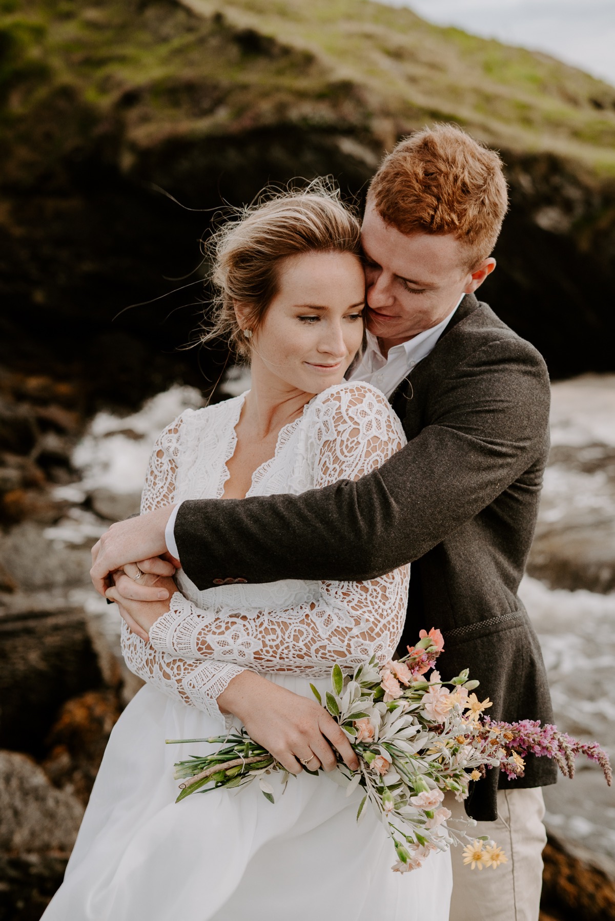 bride and groom embracing in Irish countryside