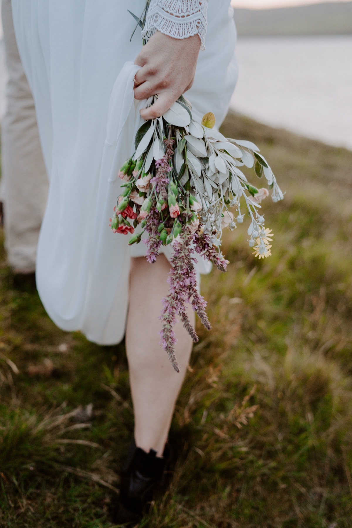 bride walking with colorful wildflower bouquet