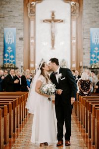 bride and groom walk up aisle catholic wedding